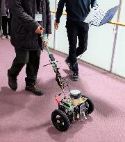 Demonstration experiment of walking guidance by a cane-type robot with wheels at Osaka City University